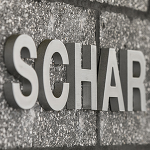 A photo of the text SCHAR on a concrete block wall.