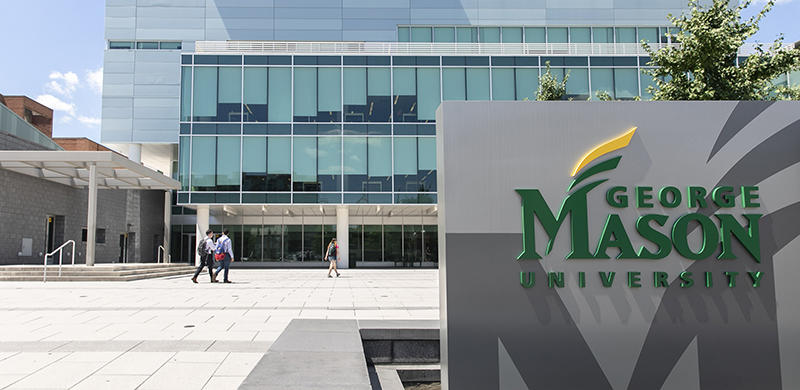 George Mason University signage in front of the Van Metre Hall building on the Arlington Campus