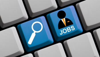 A keyboard with two blue buttons displaying a magnifying glass and a person with the text JOBS