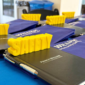 A yellow sign sitting on a notebook says “safety.”
